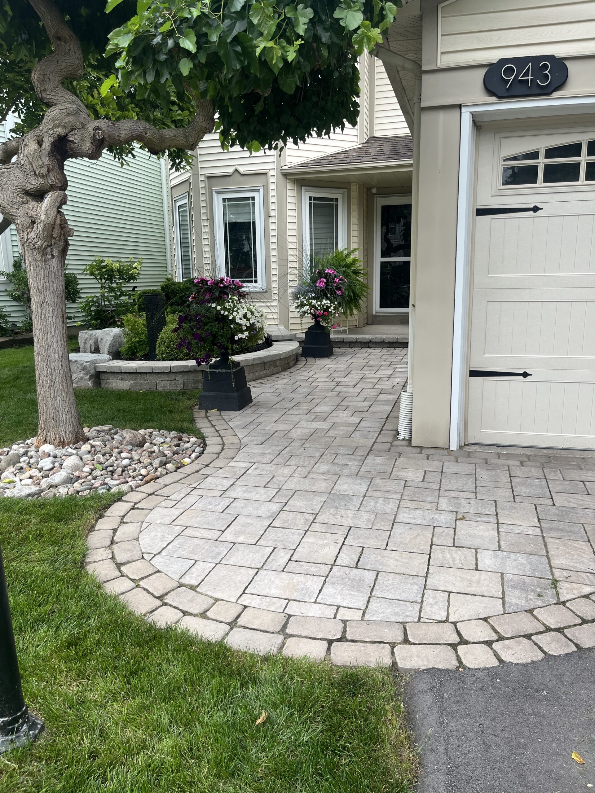 Close-up of intricate circular interlock paver pattern creating a beautiful garden walkway in Clarington